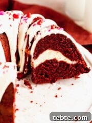 Closeup of red velvet bundt cake with cream cheese swirl and glaze