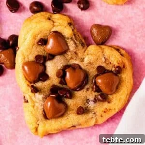 heart shaped chocolate chip cookie on counter with chocolate hearts