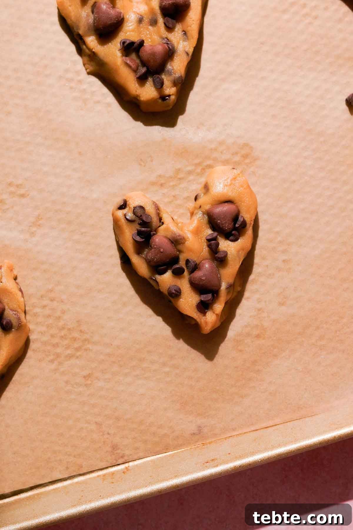 shaped cookie dough hearts with chocolate chips on top