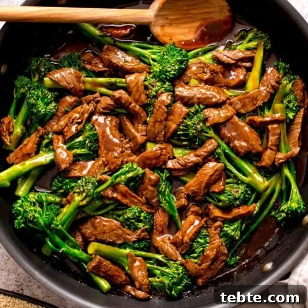 Chinese-Style Beef Curry Recipe: Savory Stir-Fry with Aromatics 9 beef and broccoli stir fry in a pan with a wooden spoon