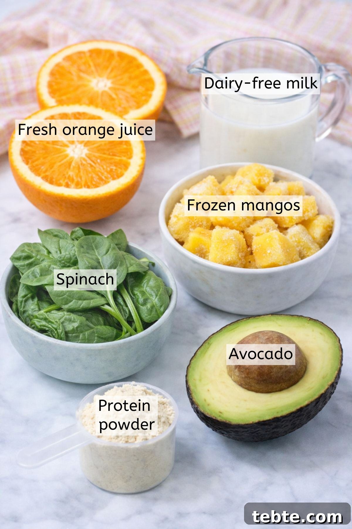 Mango Avocado Smoothie Without Banana — Creamy Tropical Drink 3 Mango, avocado, spinach, protein powder, and milk in cups with text labels over top.