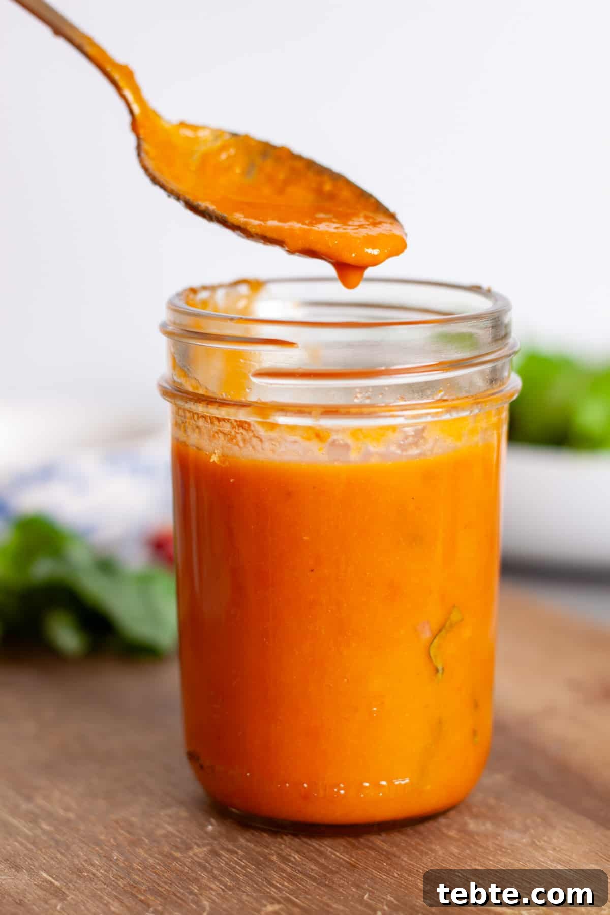 Sun-Dried Tomato Vinaigrette Recipe for Bright, Tangy Salads 2 A jar of sun-dried tomato vinaigrette with a spoonful just above the jar.