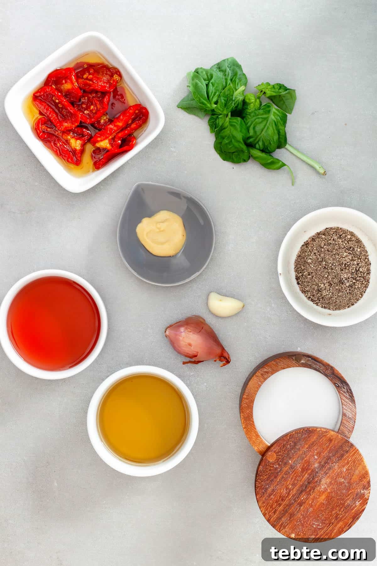 Sun-Dried Tomato Vinaigrette Recipe for Bright, Tangy Salads 3 Ingredients for a homemade sun-dried tomato dressing on a gray table.