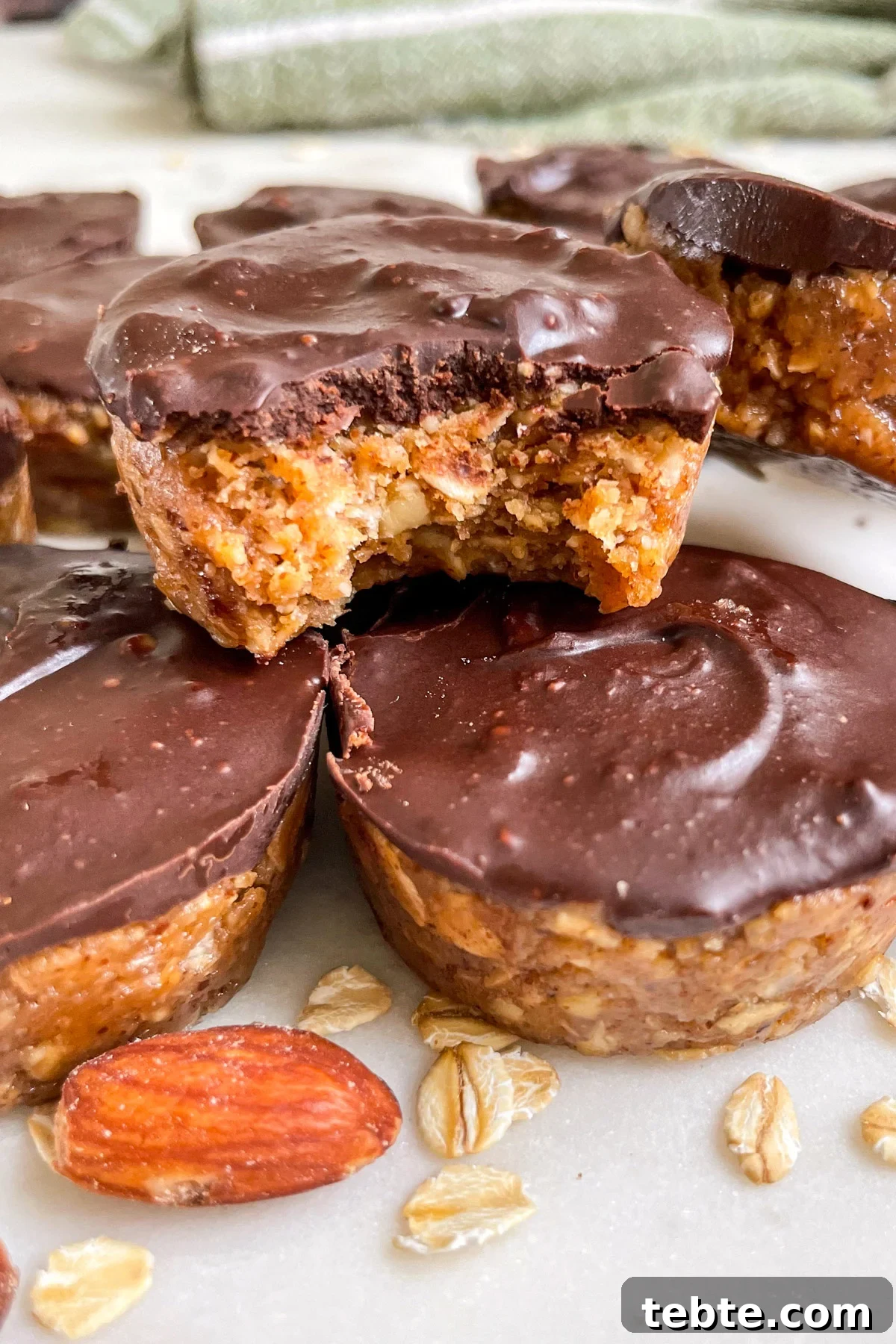 No-Bake Chocolate Almond Oat Cups — Dairy & Gluten Free 2 stacked oat cups with a bite out of one