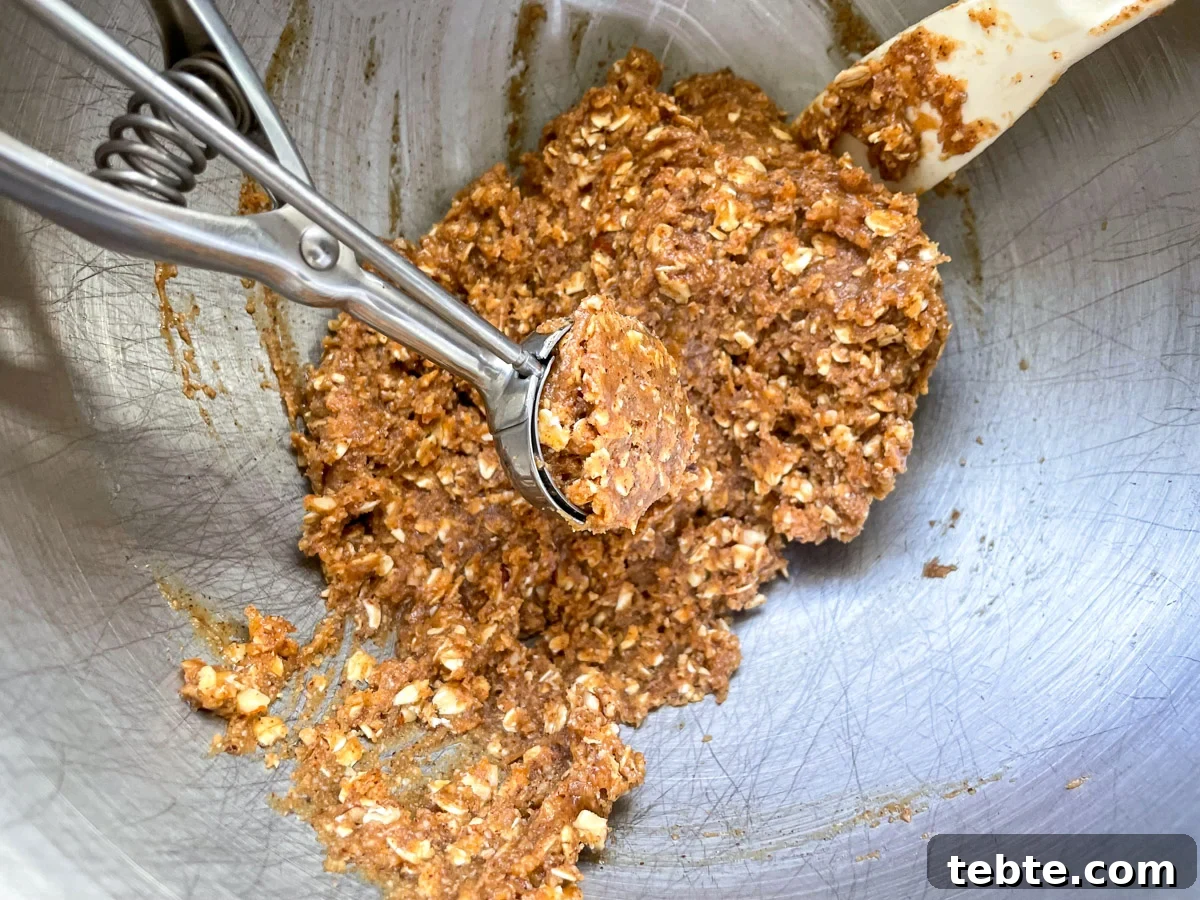 No-Bake Chocolate Almond Oat Cups — Dairy & Gluten Free 4 scooping mixed dough for oat cups