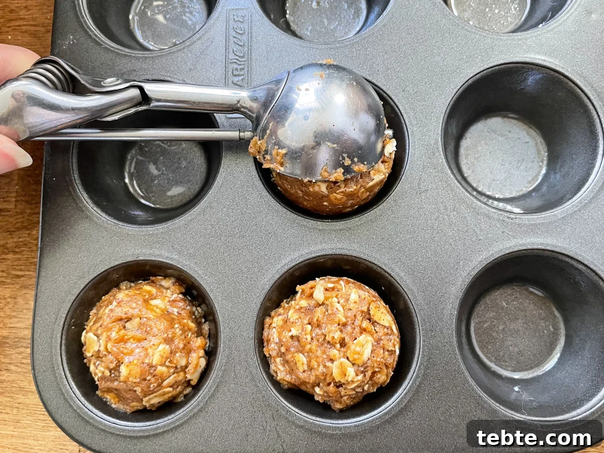 No-Bake Chocolate Almond Oat Cups — Dairy & Gluten Free 5 using scoop to portion dough into mini muffin tin