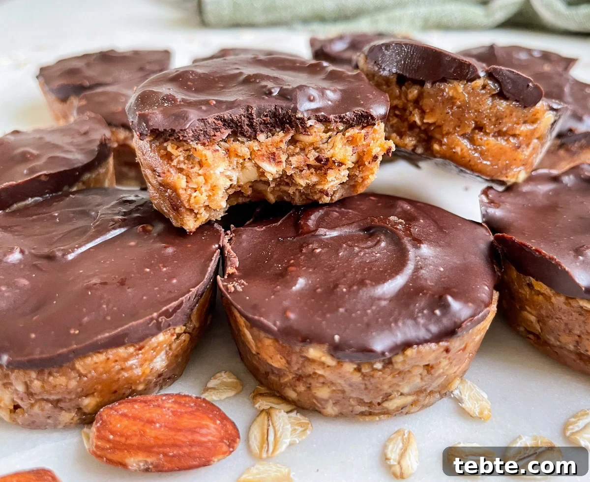 No-Bake Chocolate Almond Oat Cups — Dairy & Gluten Free 9 stacked mini oat cups with bite out of one