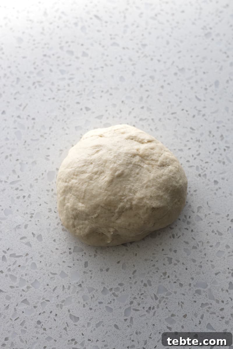 Crispy Sourdough Discard Crackers: Crunchy Homemade Recipe 5 Dough on a white stone work surface.