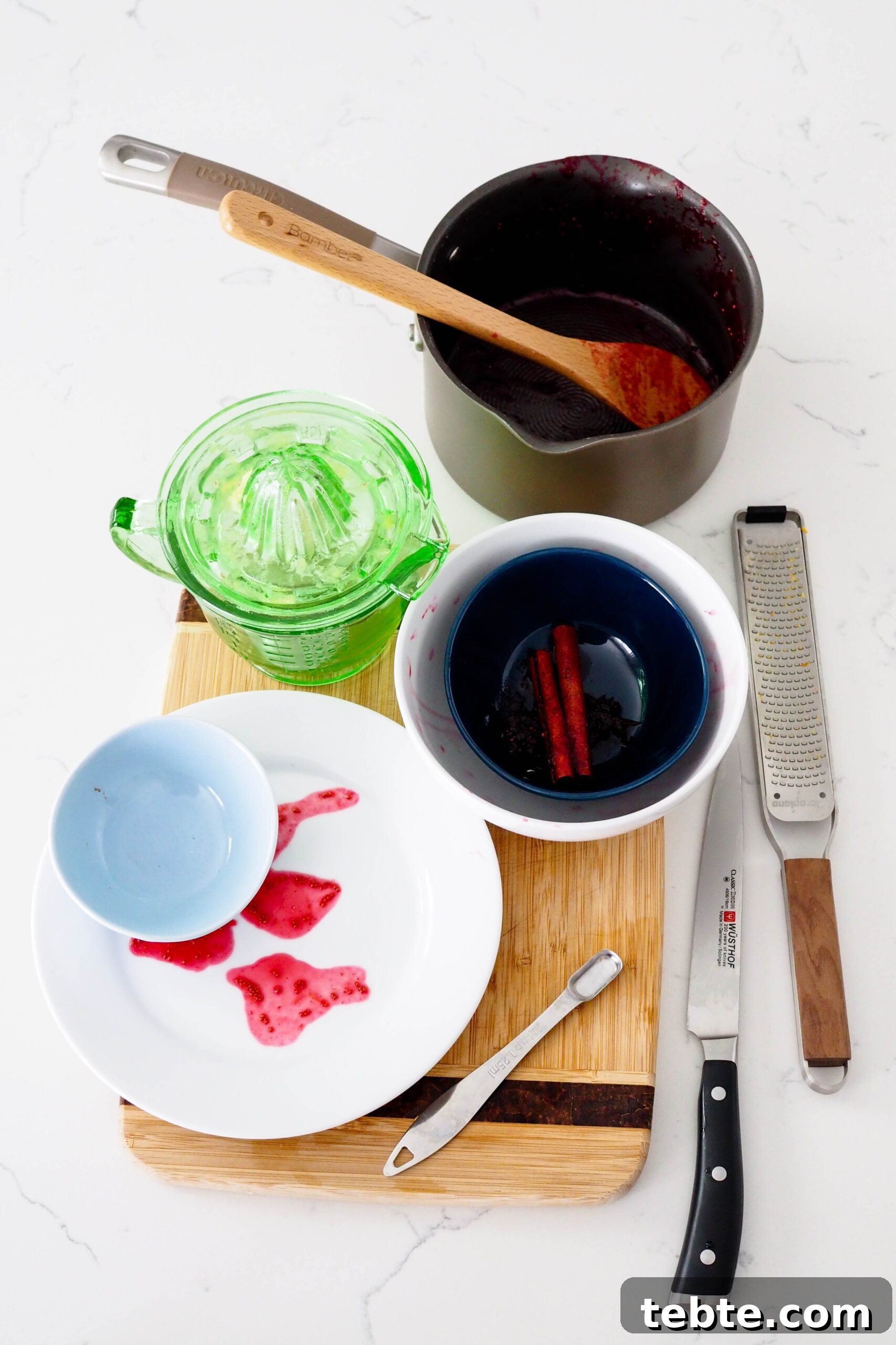 Classic Homemade Cranberry Sauce for Thanksgiving 9 A collection of dishes used in making cranberry orange sauce.