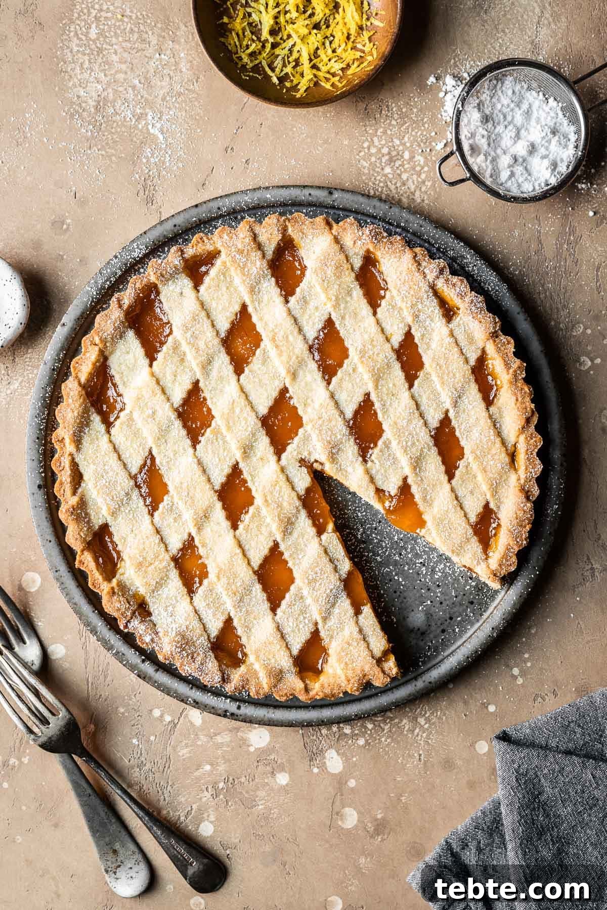 Classic Italian Jam Tart (Crostata) Recipe 2 A lattice topped crostata di marmellata with one slice removed.