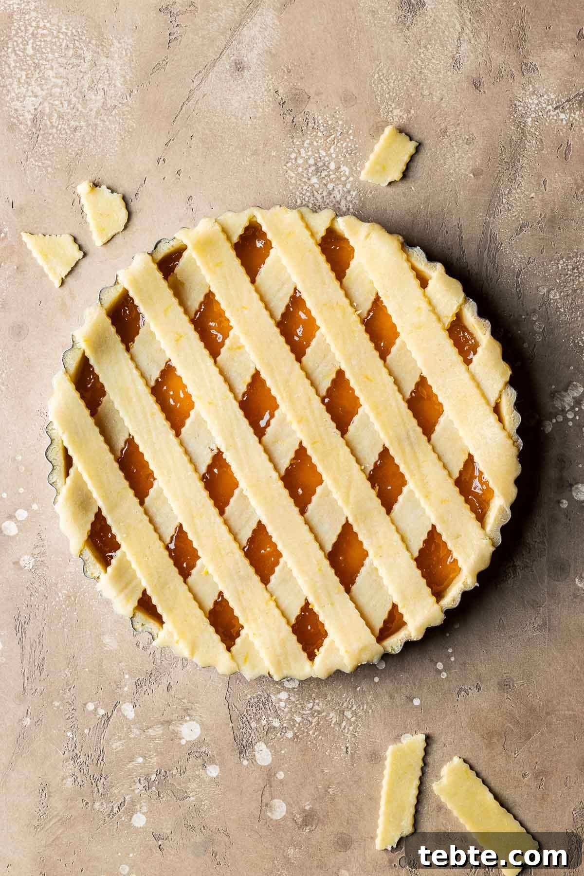 Classic Italian Jam Tart (Crostata) Recipe 12 An unbaked crostata di marmellata with strips of lattice dough on top.