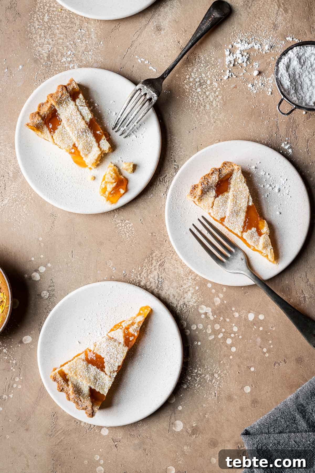 Classic Italian Jam Tart (Crostata) Recipe 15 Three slices of lattice topped jam tart on tan plates.