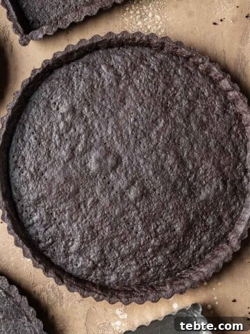 A round baked chocolate tart crust.