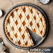 Classic Italian Jam Tart (Crostata) Recipe 21 A lattice topped crostata di marmellata with one slice removed.