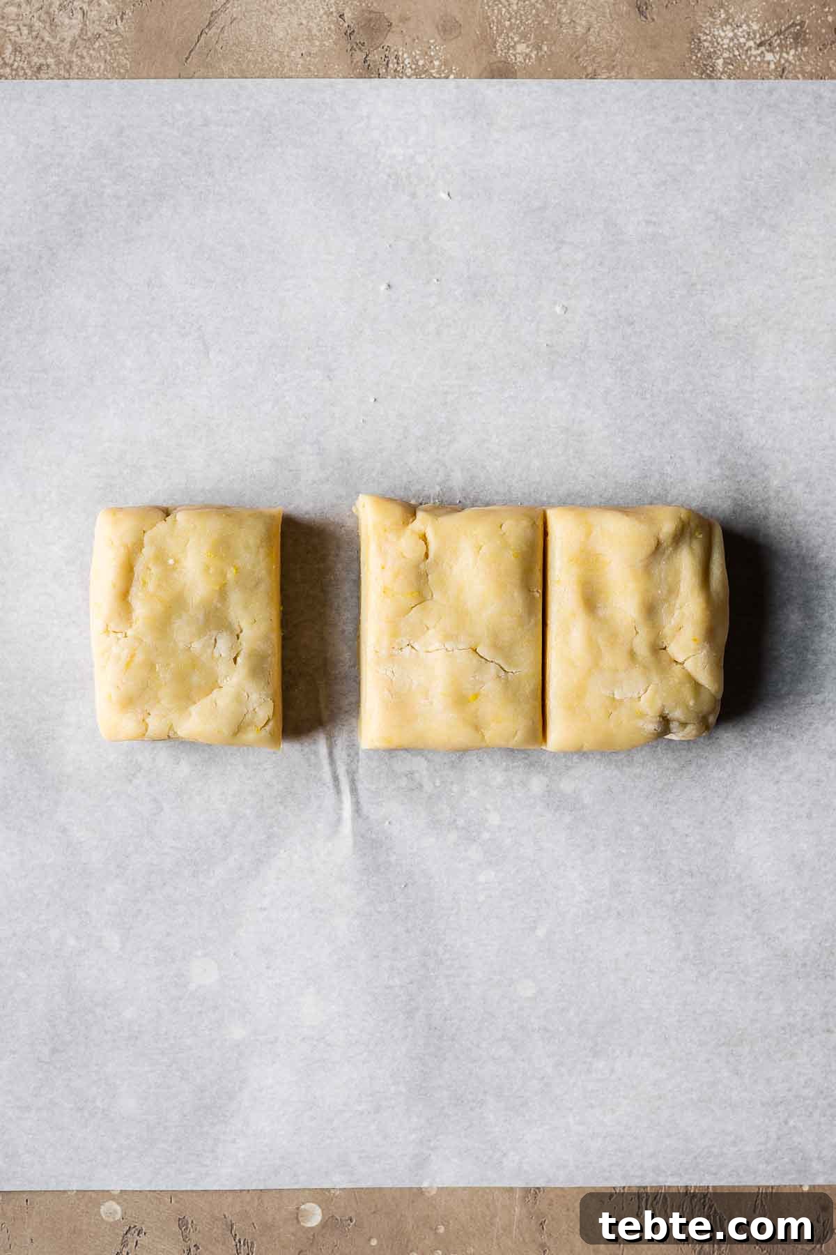 Classic Italian Jam Tart (Crostata) Recipe 7 Shortcrust pastry dough divided into thirds on parchment paper.