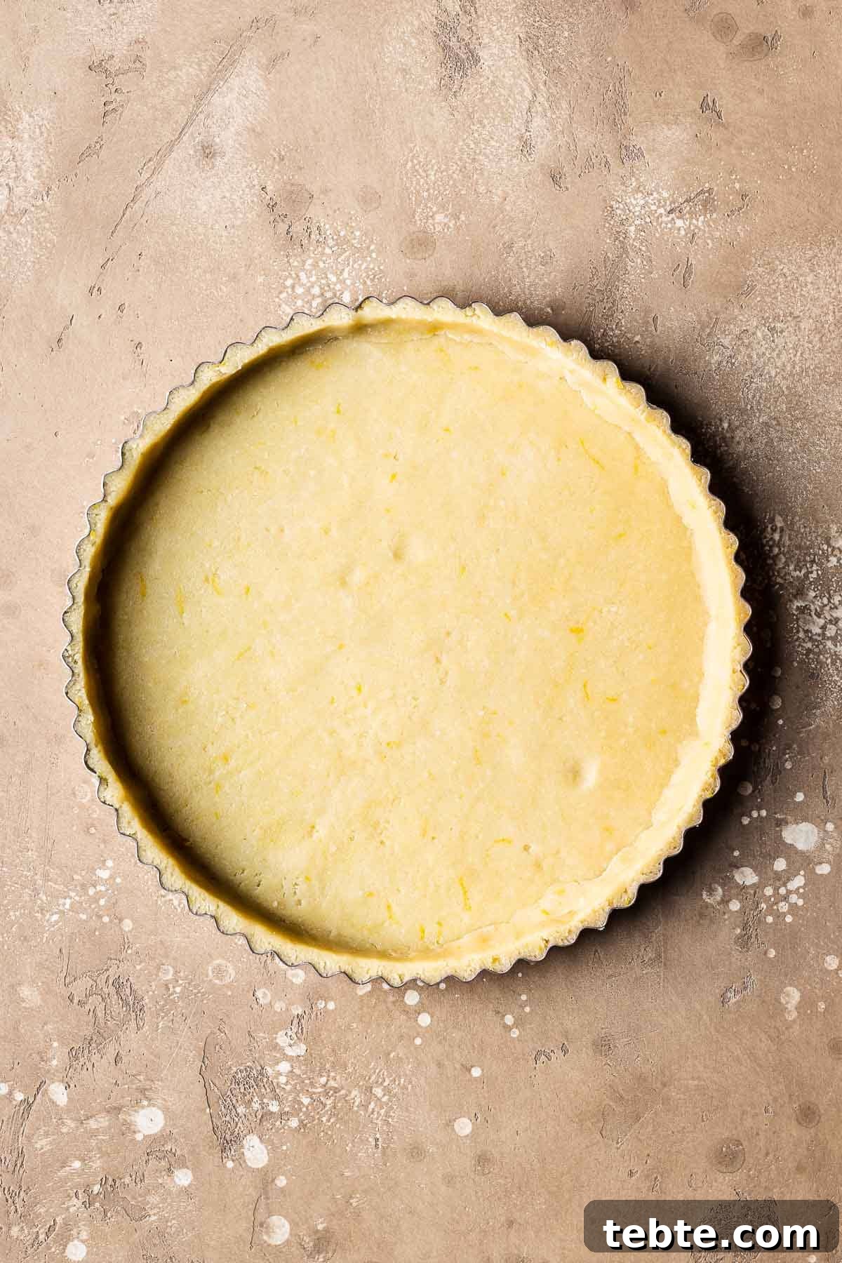 Classic Italian Jam Tart (Crostata) Recipe 9 Unbaked pastry dough in a fluted tart pan.