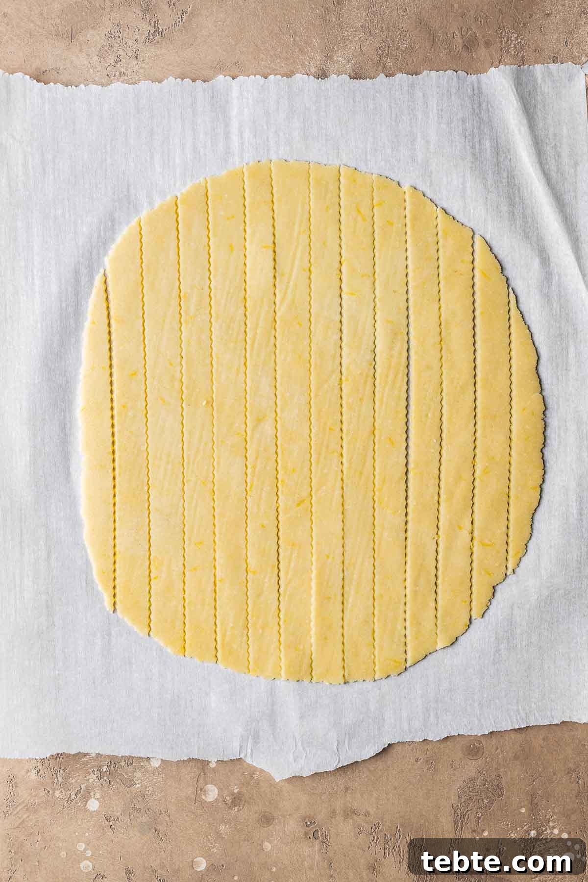 Classic Italian Jam Tart (Crostata) Recipe 10 Lattice dough strips on white parchment paper.