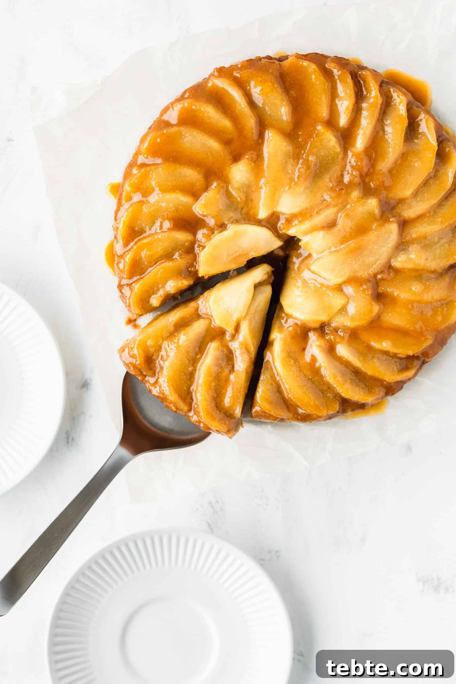Moist Vegan Apple Cake Recipe with Cinnamon and Maple Glaze 5 Vegan apple upside-down cake with a slice cut out.