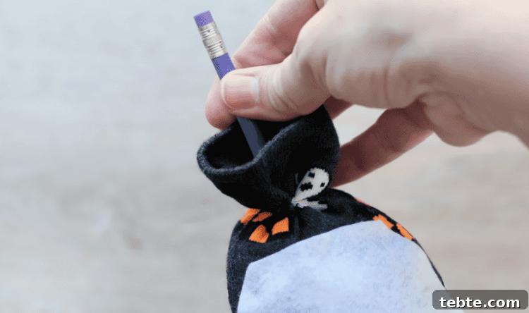 No-Sew Halloween Gnomes Made from Socks 12 Pencil sticking out of sock gnome top.