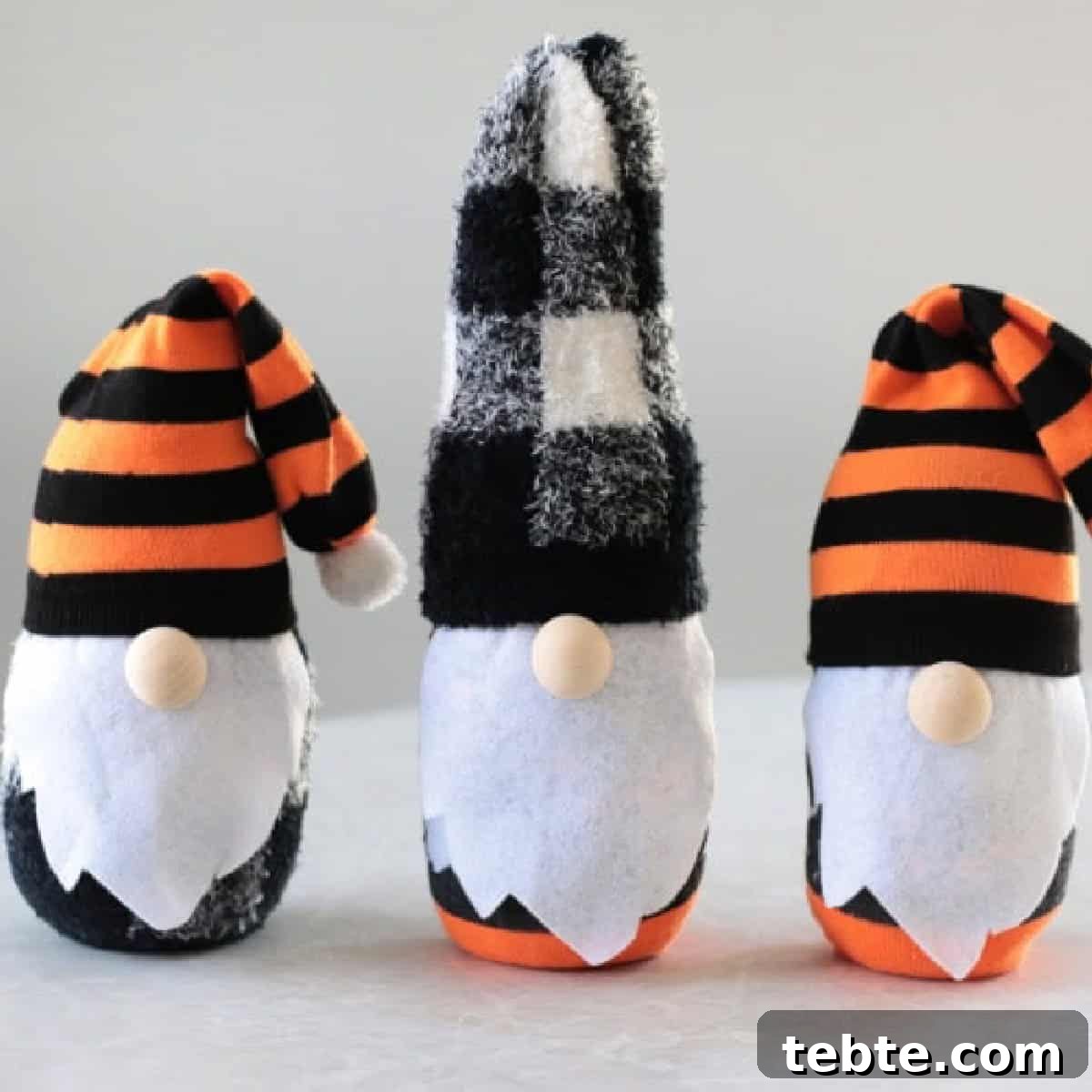 No-Sew Halloween Gnomes Made from Socks 17 Three Halloween themed sock gnomes on a table.