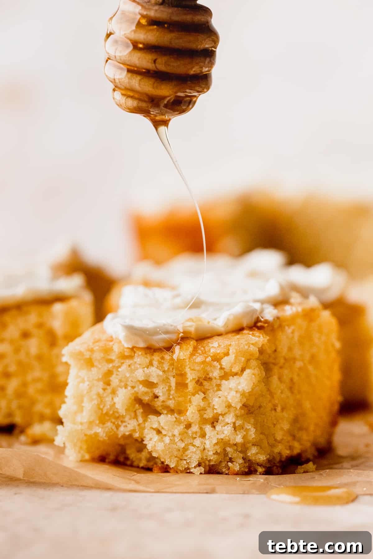 Honey Butter Cornbread Recipe: Sweet, Buttery Southern Cornbread 3 Drizzling honey on top of cornbread.