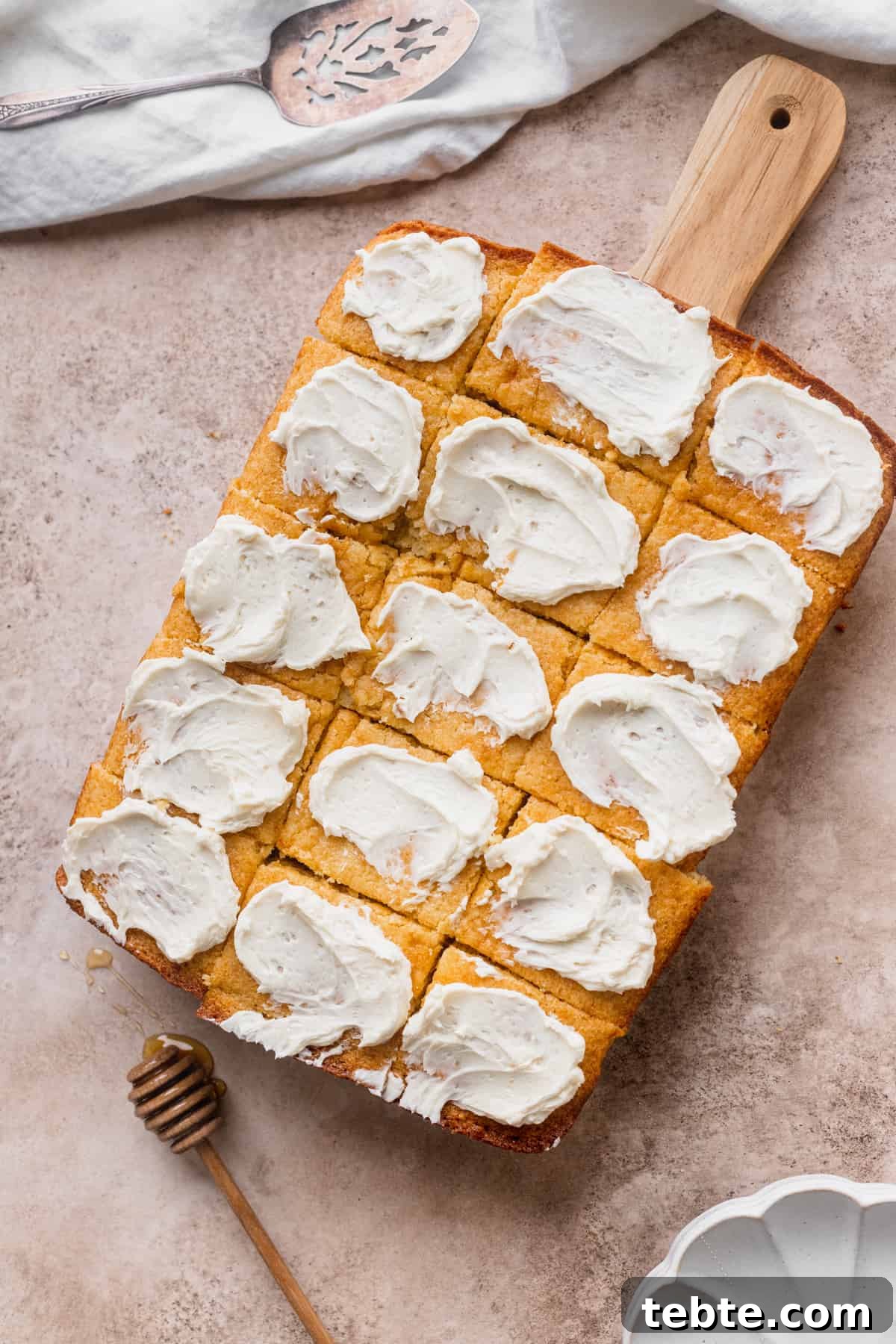 Honey Butter Cornbread Recipe: Sweet, Buttery Southern Cornbread 9 Cornbread with butter on top of cutting board.