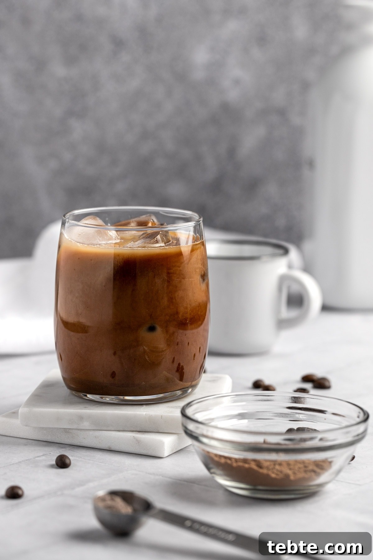 Protein Iced Coffee Recipe: High-Protein Chilled Coffee Drink 7 Protein coffee on marble coasters, with a white background.