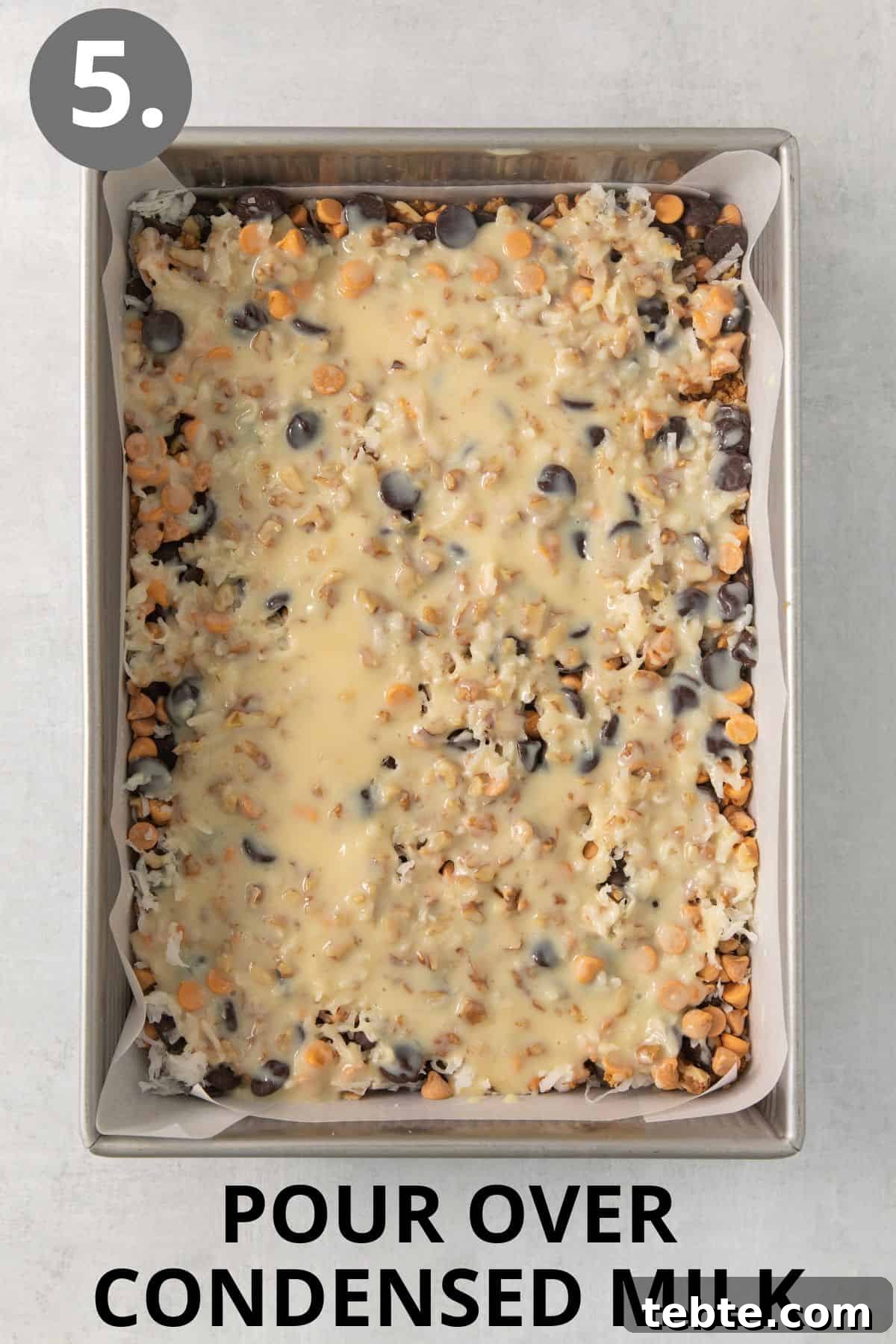 Gluten-Free 7-Layer Cookie Bars: Chewy Chocolate & Coconut Delight 8 Condensed milk poured over the 7-layer bars