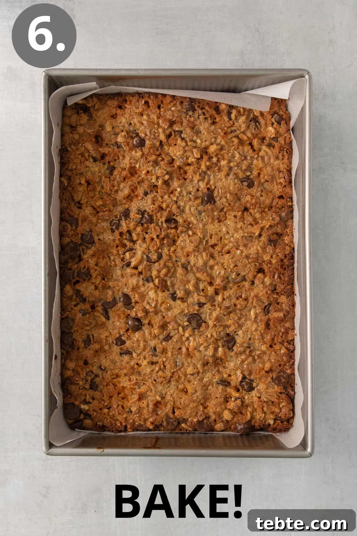 Gluten-Free 7-Layer Cookie Bars: Chewy Chocolate & Coconut Delight 9 Baked 7-layer bars in a pan