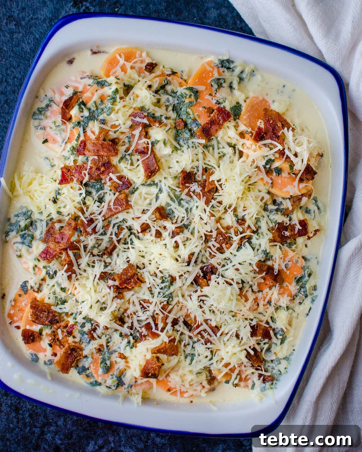 Savory Sweet Potato Casserole with Herbed Panko Topping 6 The layered sweet potato casserole in a baking dish ready to go into the oven.