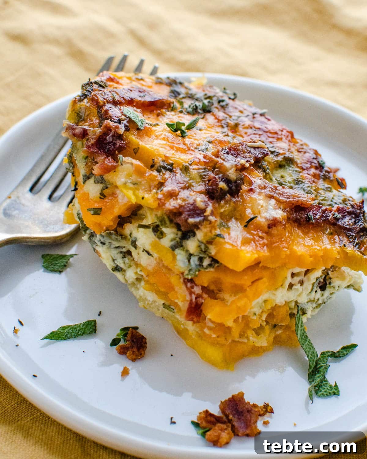 Savory Sweet Potato Casserole with Herbed Panko Topping 8 Serving the savory sweet potato casserole on a plate.