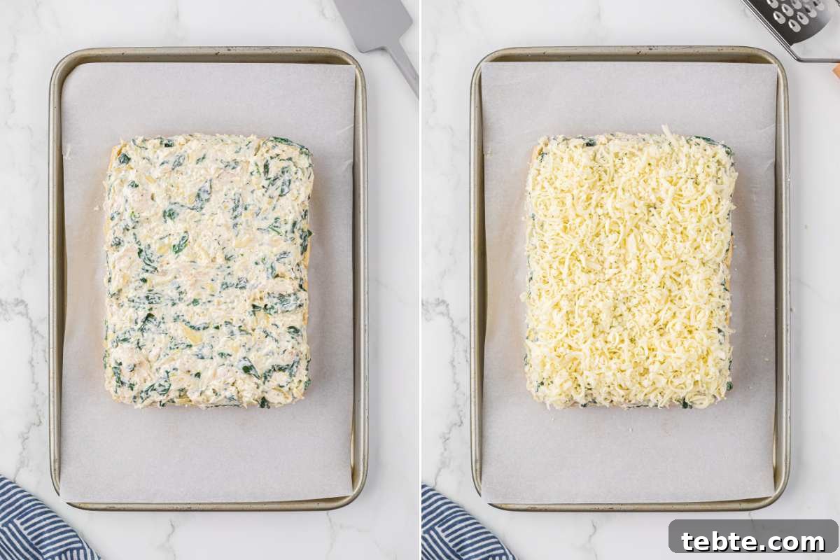 Creamy Chicken and Artichoke Sliders: Savory Party Bites 9 baking sheet with creamy filling and shredded cheese on top of slider bottoms.
