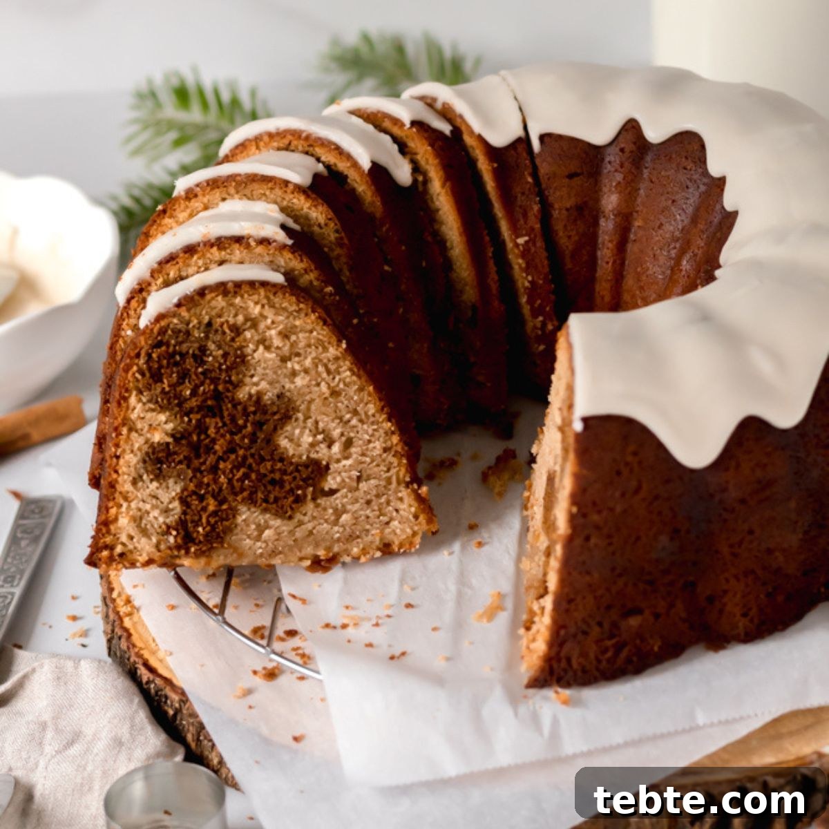 Spiced Gingerbread Bundt Cake Recipe with Molasses Glaze 2 A bundt cake cut into slices revealing gingerbread men baked inside.