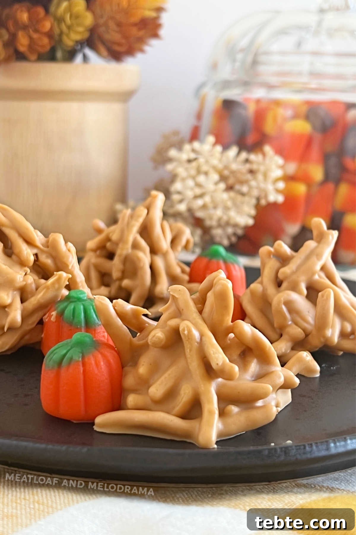 No-Bake Chocolate Haystack Cookies 2 no bake haystack cookies with butterscotch morsels and marshmallow pumpkins on plate