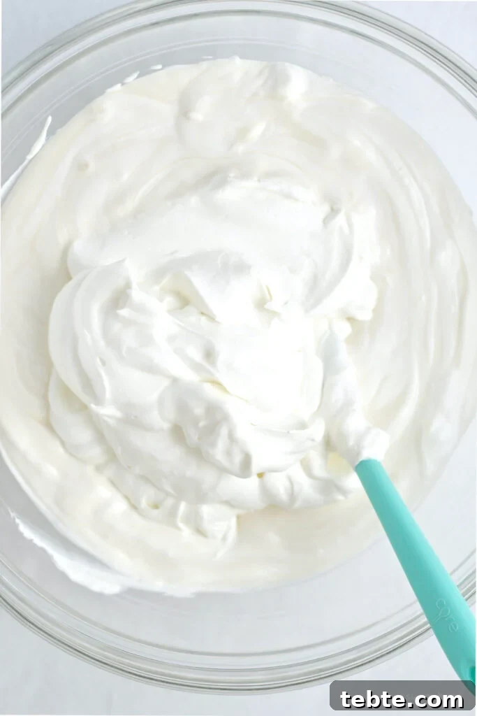 whipped cream added to sweetened condensed milk mixture