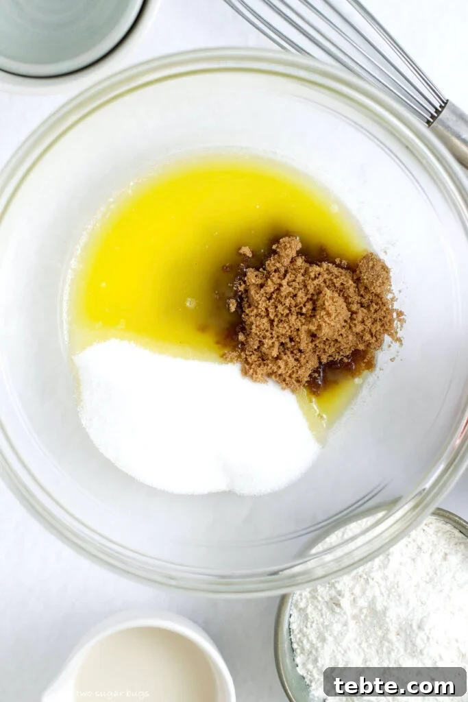 melted butter, brown sugar and granulated sugar in a mixing bowl