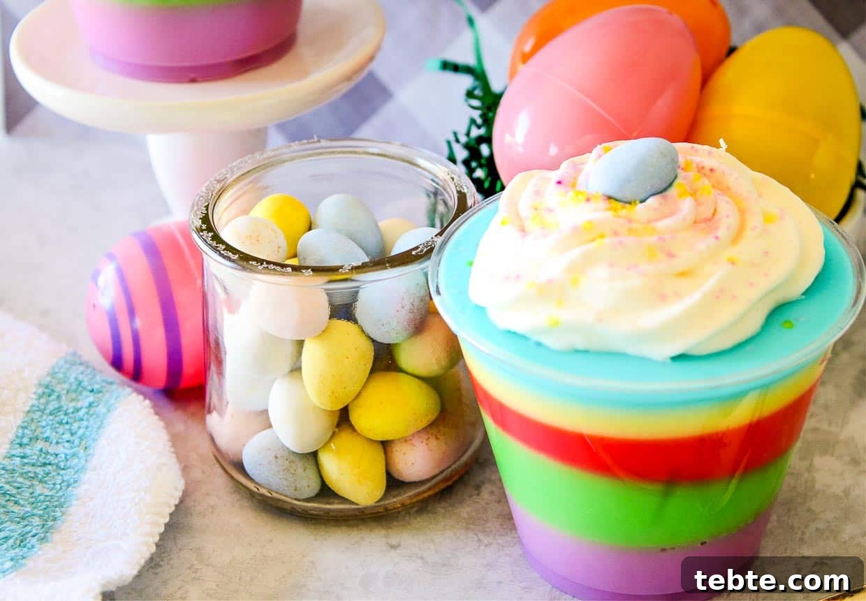 15 Easter Recipes Your Family Will Beg to Eat This Year 14 A colorful easter dessert in a cup with eggs and candy.