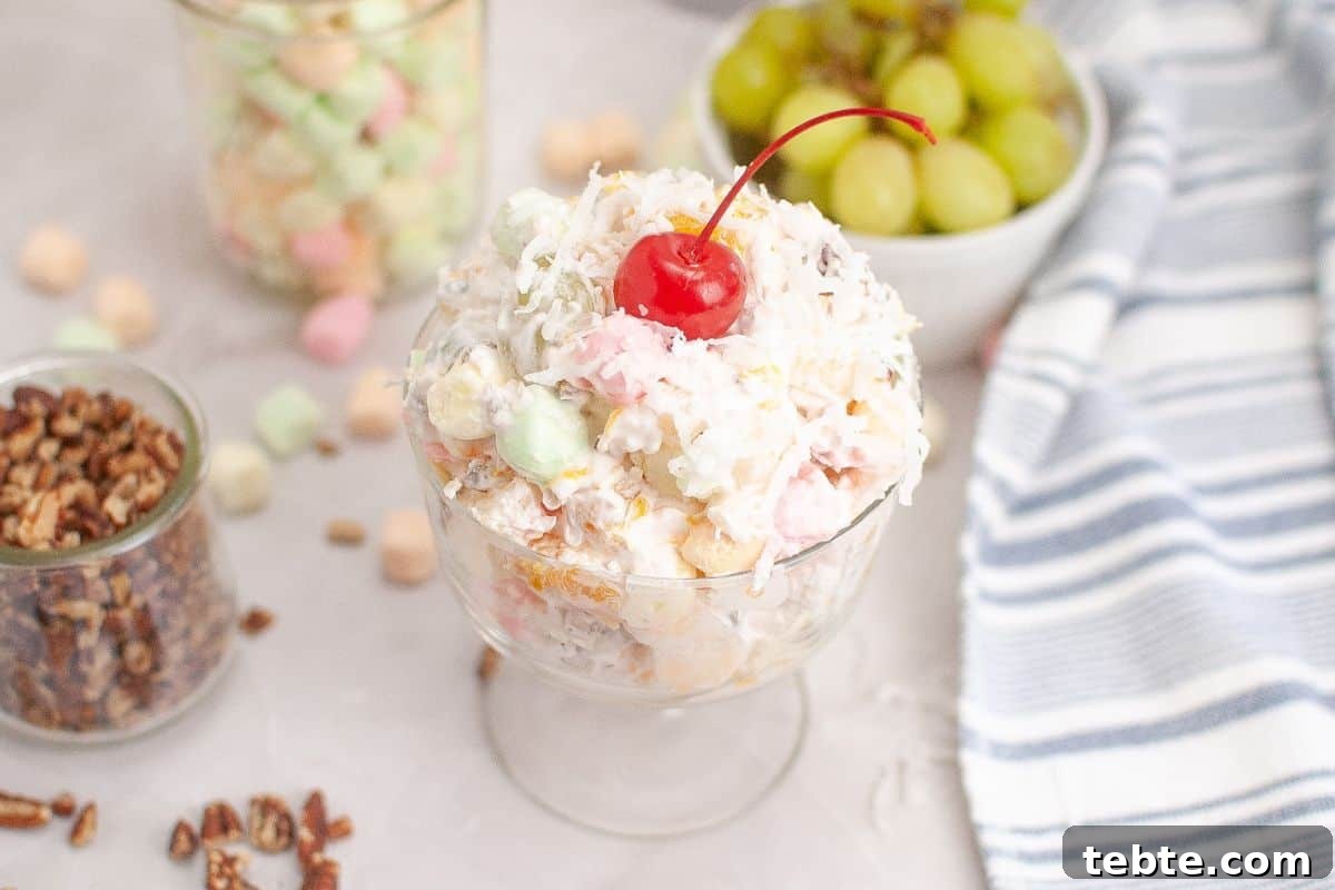 15 Easter Recipes Your Family Will Beg to Eat This Year 3 A colorful Ambrosia Salad beautifully arranged in a serving bowl.