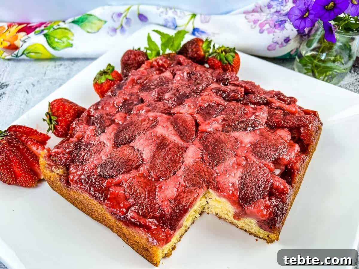 15 Easter Recipes Your Family Will Beg to Eat This Year 6 Strawberry Upside Down Cake with a slice missing.