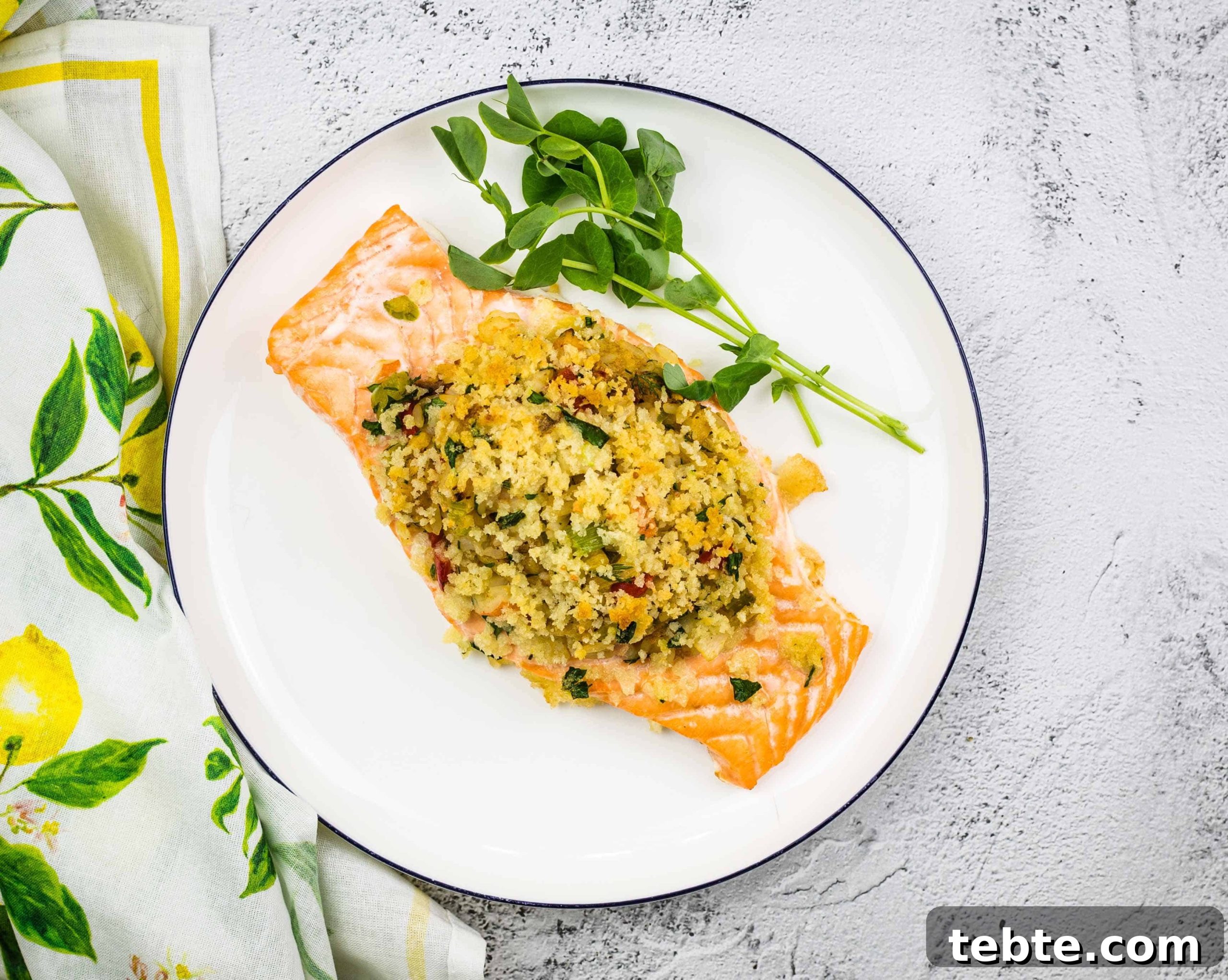 15 Easter Recipes Your Family Will Beg to Eat This Year 8 Seafood Stuffed Salmon on a circular white plate.