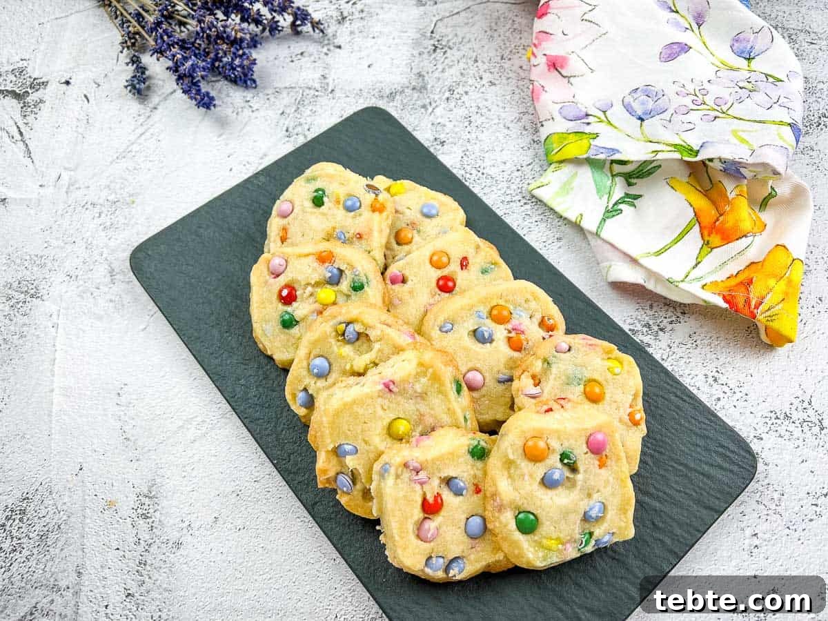 15 Easter Recipes Your Family Will Beg to Eat This Year 10 Shortbread M&M cookies on a black slate.