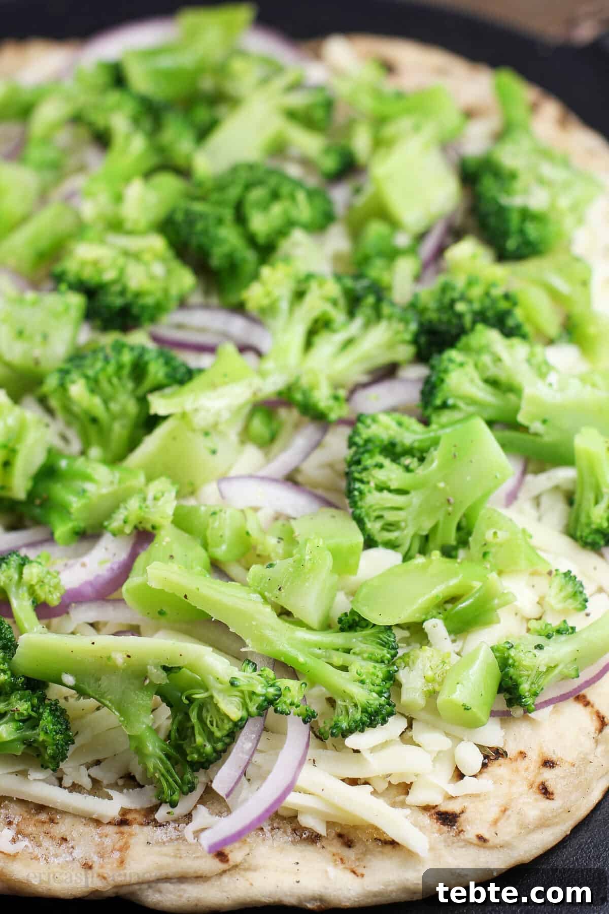assembled pizza prior to cooking to show ingredients