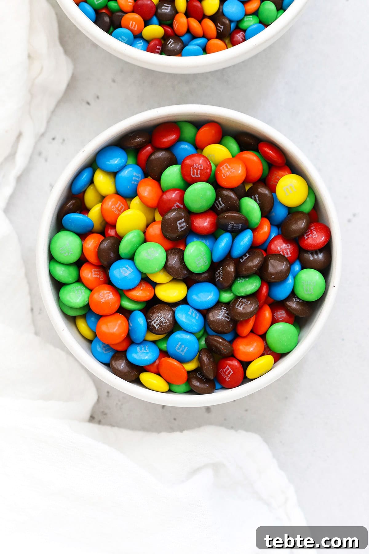 Overhead bowl of colorful m&ms in a white bowl