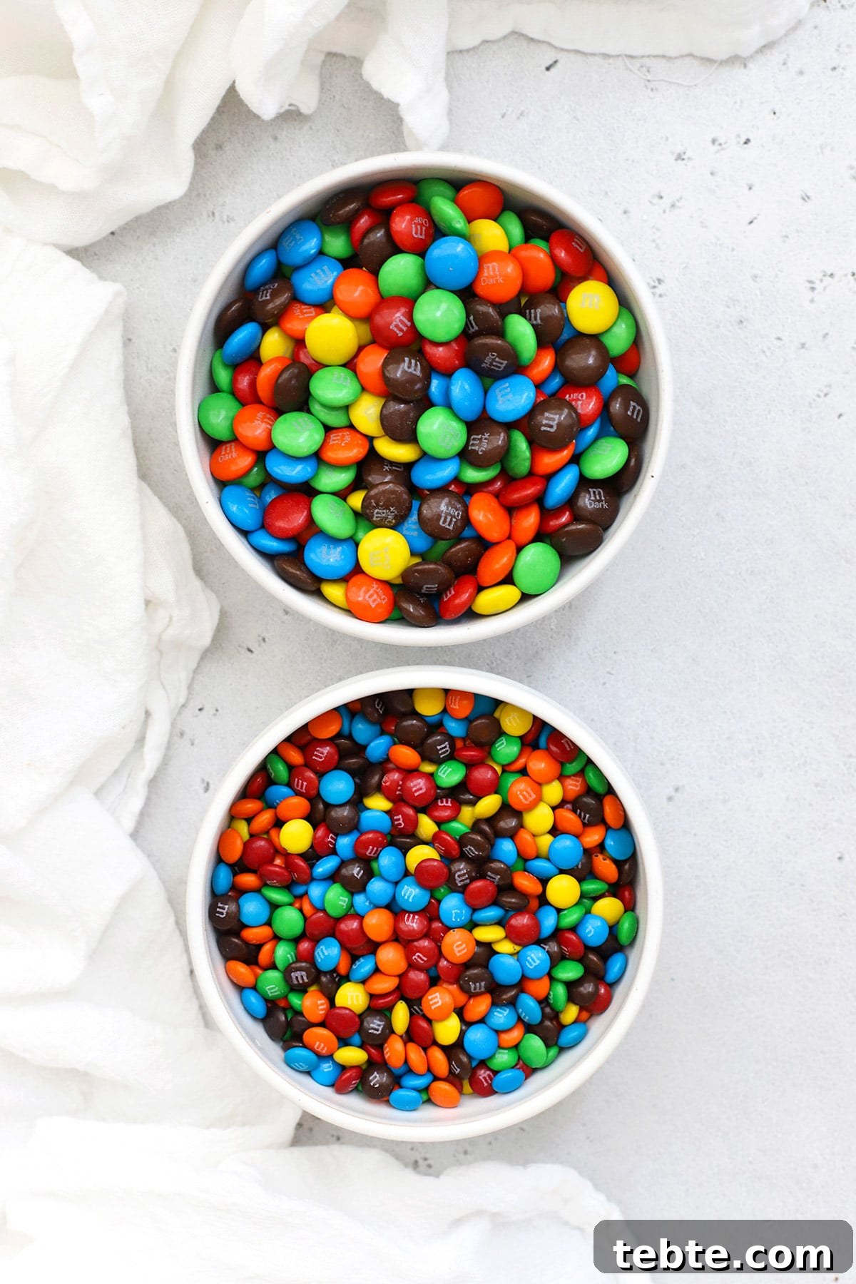 Two bowls of M&Ms, one with mini M&Ms