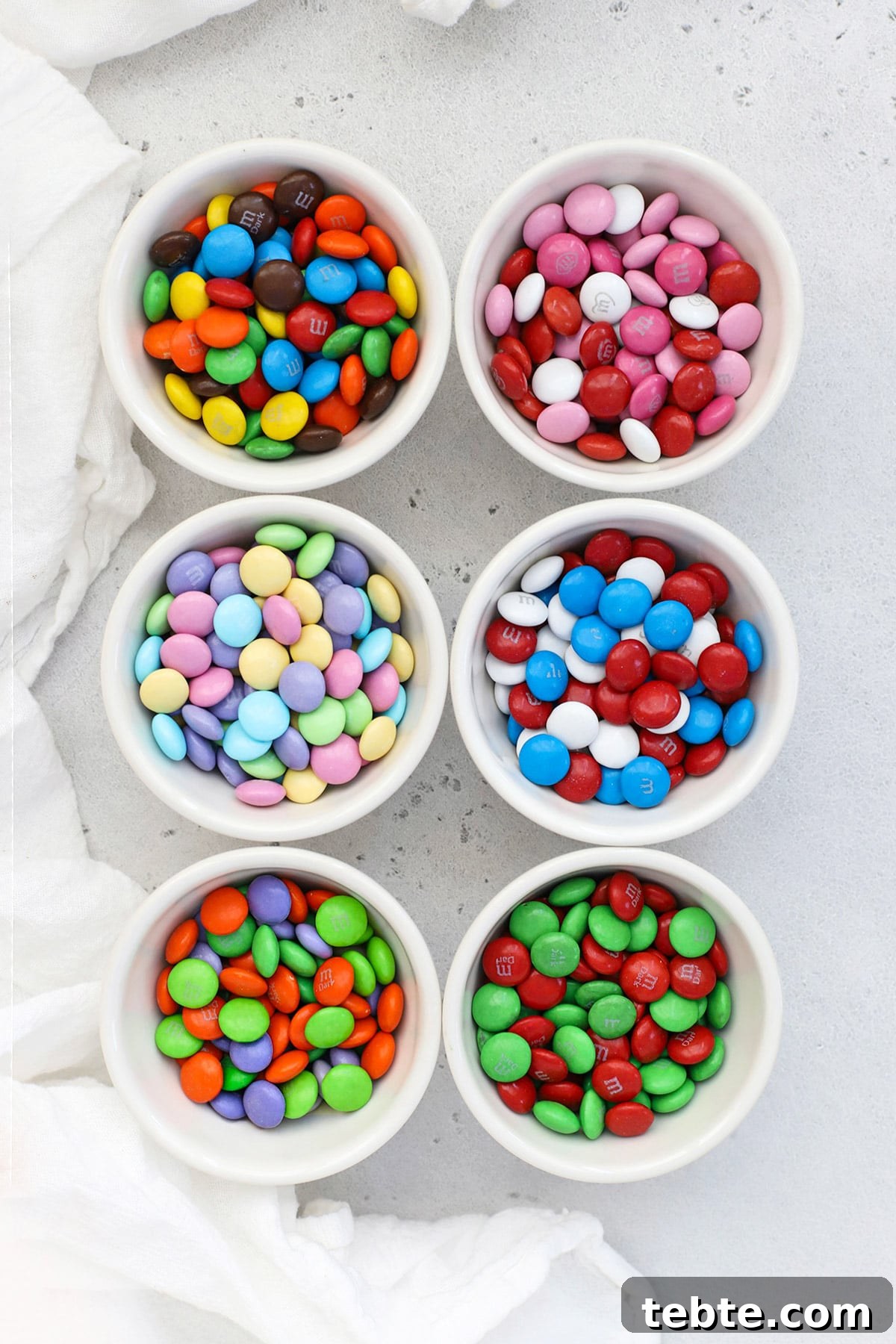 Small bowls of holiday M&Ms in various colorways