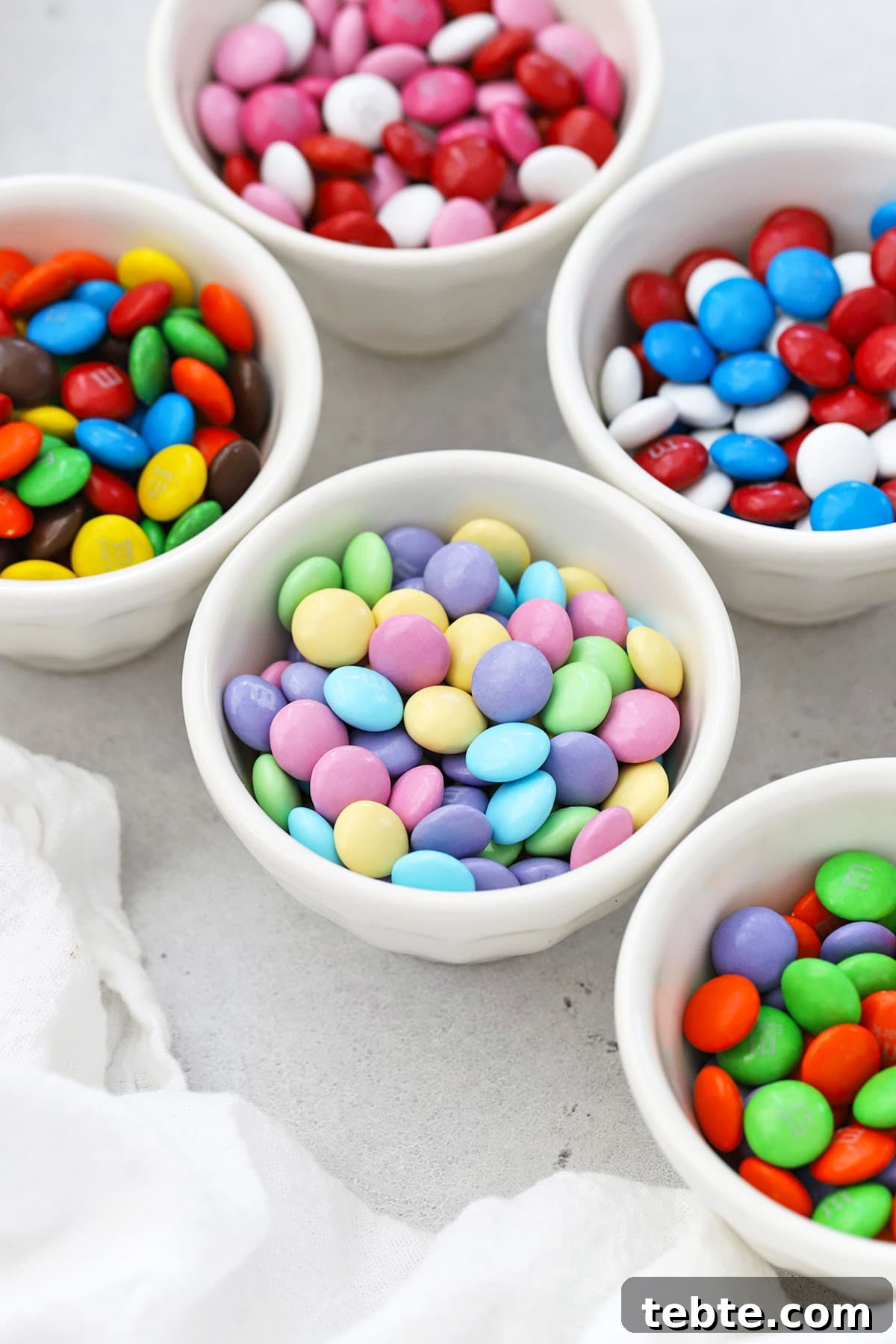 Front view of small bowls of holiday M&Ms in various colors