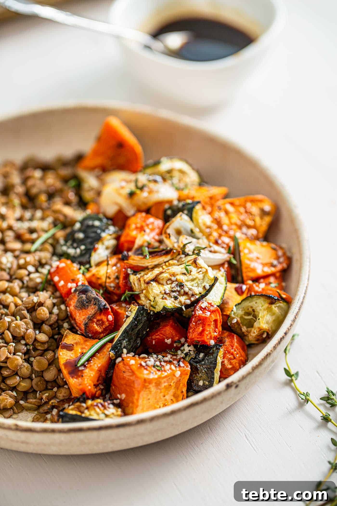 41 Fresh Fall Salad Recipes to Try This Season 18 A stone bowl full of roasted zucchini, sweet potatoes, and carrots, with lentils on one side. A sprig of thyme sits next to the bowl and a bowl of balsamic dressing sits above the salad.