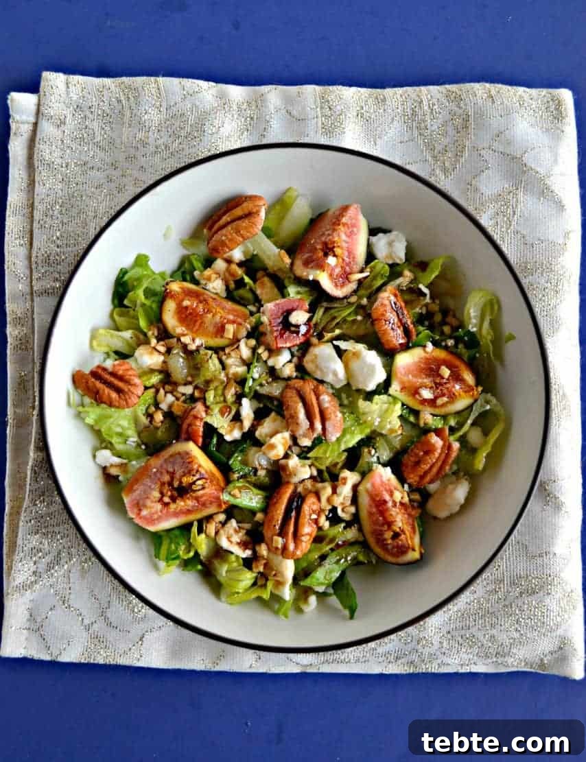 41 Fresh Fall Salad Recipes to Try This Season 28 A bowl sitting on a decorative gold napkin on a blue table. The bowl is filled with greens, pecan halves, figs and chunks of blue cheese.
