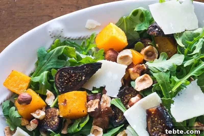 41 Fresh Fall Salad Recipes to Try This Season 34 A white plate full of green arugula, diced squash, sliced figs, chopped hazelnuts and shaved parmesan.