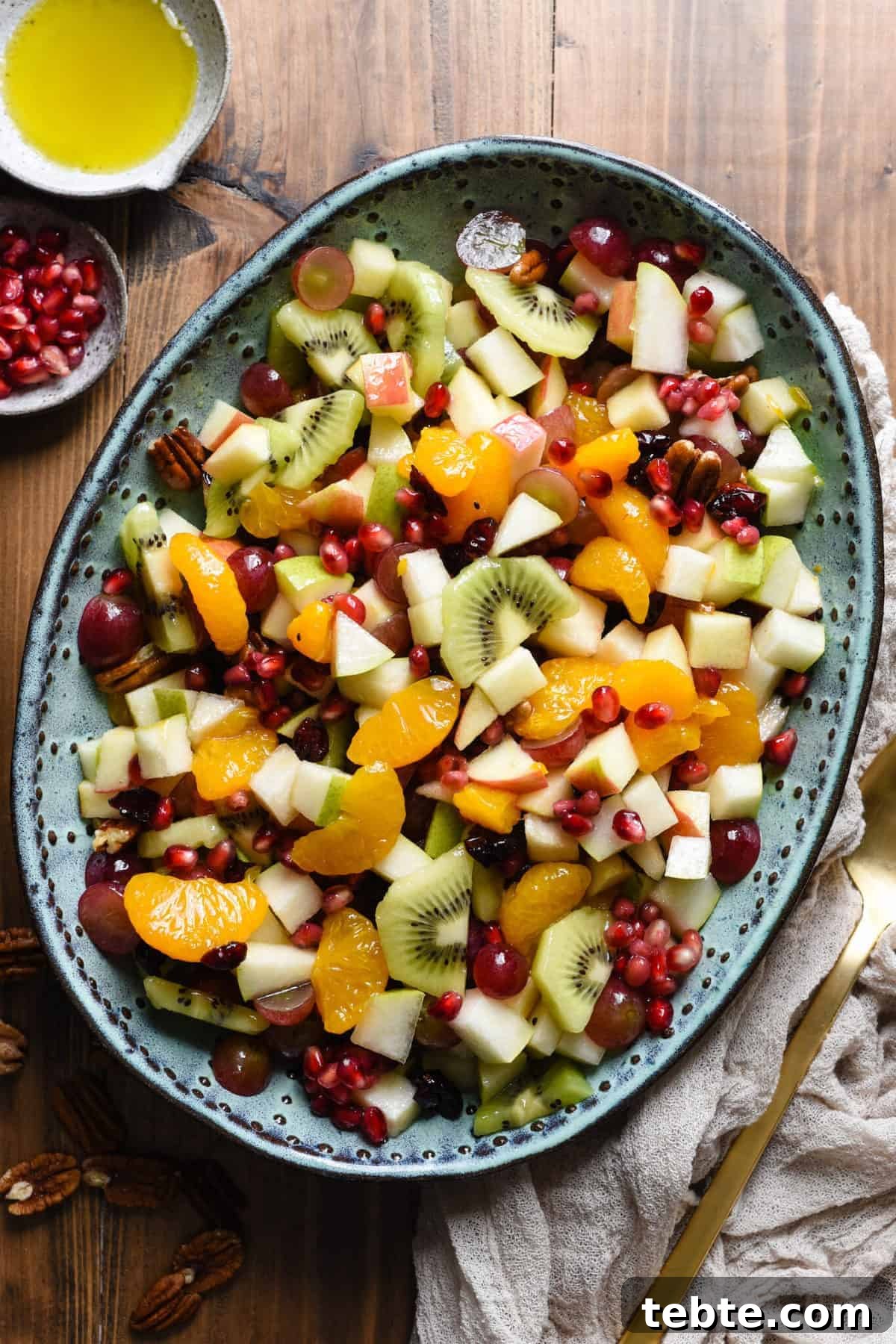 41 Fresh Fall Salad Recipes to Try This Season 37 A mixture of colorful fruit is served on a blue platter. Extra dressing and pomegranate seeds are show top left, with a serving utensil sits bottom right. Extra pecans are sprinkled around the platter.